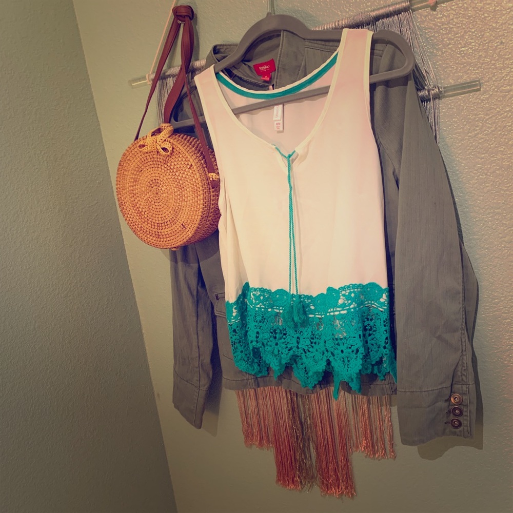 Sleeveless tank with green lace detail.